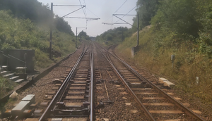 Dual track, with another track leading onto the main track on the right, and another track branching from the track on the left